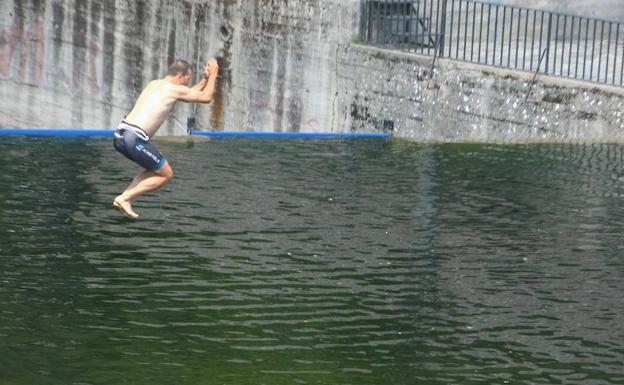 Una persona se refresca en el río Meruelo en Molinaseca.