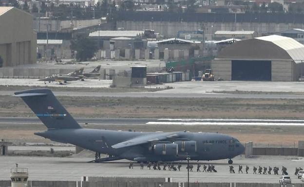 Los últimos soldados estadounidenses en Afganistán suben a un avión de transporte para salir del país./AFP