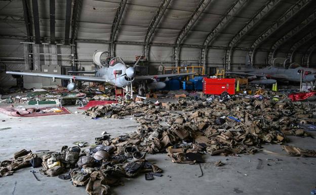Abandoned plane and military equipment at Kabul airport.