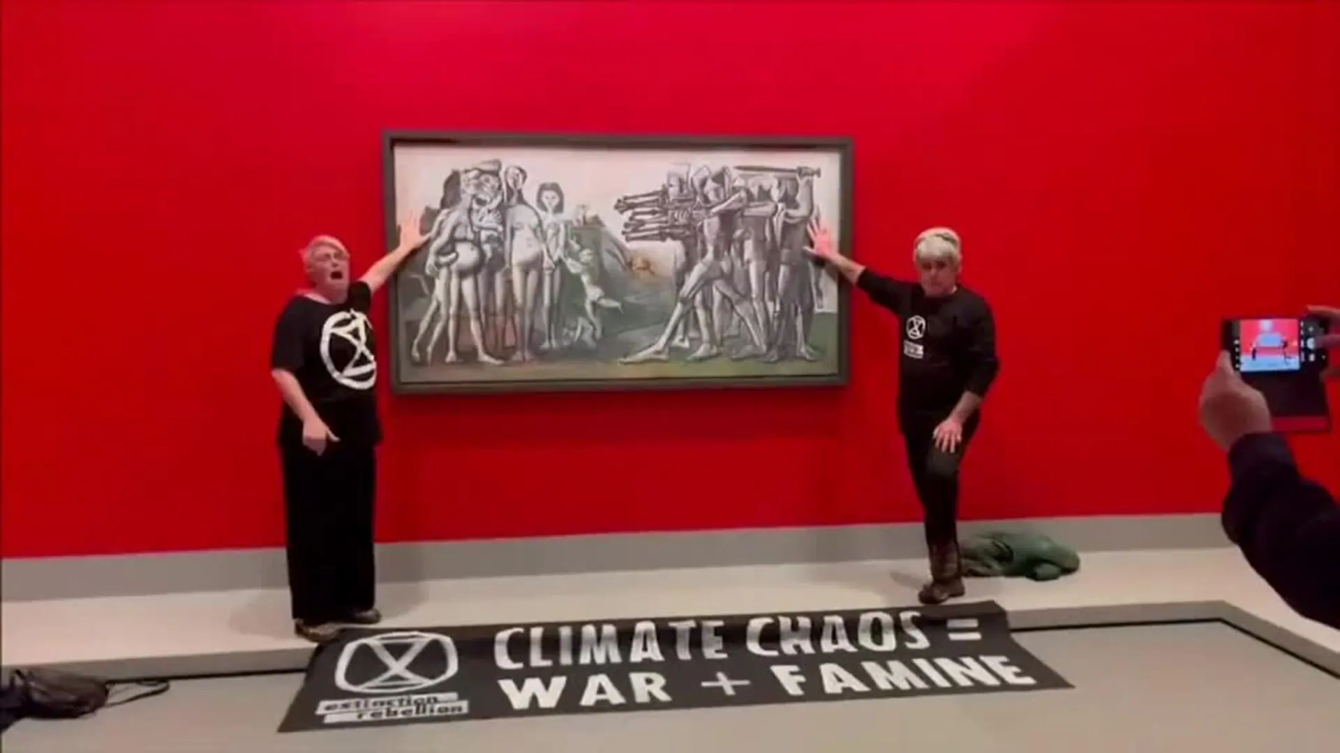 Extinction Rebellion activists glue their hands to a Picasso painting